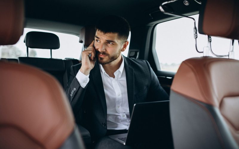 handsome-business-man-working-computer-car_1303-16420